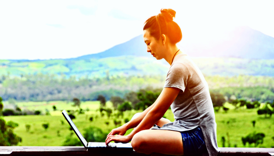Woman with computer outside.